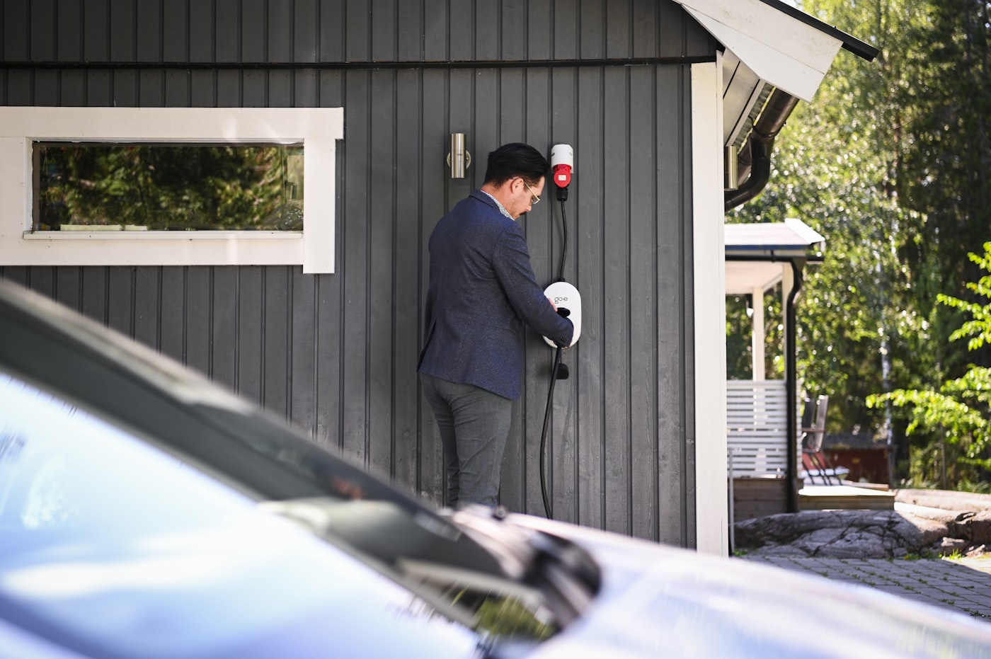 Hand plugging in an electric vehicle charging cable
